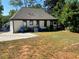 House with backyard, driveway, and surrounding trees at 1677 S Gordon Sw St, Atlanta, GA 30310