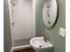 Modern bathroom with white tile shower and pedestal sink at 1677 S Gordon Sw St, Atlanta, GA 30310
