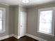 Spacious bedroom with neutral walls, hardwood floors, and two windows at 1677 S Gordon Sw St, Atlanta, GA 30310