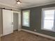 Bright bedroom with carpet, barn door, and two windows at 1677 S Gordon Sw St, Atlanta, GA 30310