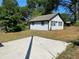 Small guest house with light blue door and concrete patio at 1677 S Gordon Sw St, Atlanta, GA 30310