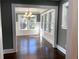 Dark hardwood floors and view into updated bathroom at 1677 S Gordon Sw St, Atlanta, GA 30310
