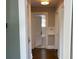 Bright hallway with dark hardwood floors and access to bathroom at 1677 S Gordon Sw St, Atlanta, GA 30310