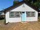 Front view of charming house with light blue door at 1677 S Gordon Sw St, Atlanta, GA 30310