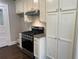 Stainless steel range and ample off-white cabinetry in kitchen at 1677 S Gordon Sw St, Atlanta, GA 30310