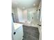 Bathroom featuring modern tile flooring, glass-enclosed shower, and separate tub at 738 Crossroad Ct, Powder Springs, GA 30127