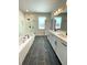 Bathroom boasts dual sink vanity, tub, and a separate glass shower at 738 Crossroad Ct, Powder Springs, GA 30127
