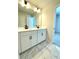 Bathroom boasts double vanity, and elegant tile floor at 738 Crossroad Ct, Powder Springs, GA 30127