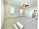 Spacious carpeted bedroom with neutral walls and a ceiling fan at 738 Crossroad Ct, Powder Springs, GA 30127