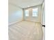 Bedroom with carpeted floors, neutral-colored walls, and two windows for natural light at 738 Crossroad Ct, Powder Springs, GA 30127
