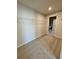 Carpeted walk-in closet with shelving; laundry room in background at 738 Crossroad Ct, Powder Springs, GA 30127