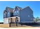 Beautiful two-story home featuring navy siding, white brick accents, and a charming covered porch at 738 Crossroad Ct, Powder Springs, GA 30127