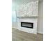 Modern electric fireplace with stone surround and mantle at 738 Crossroad Ct, Powder Springs, GA 30127