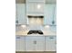 The kitchen featuring white cabinets, quartz countertops, and a stainless steel stovetop at 738 Crossroad Ct, Powder Springs, GA 30127