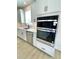 Modern kitchen featuring stainless steel appliances and sleek white cabinetry at 738 Crossroad Ct, Powder Springs, GA 30127