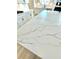 Close-up of a kitchen island featuring white quartz countertop with grey veining and light wood floors at 738 Crossroad Ct, Powder Springs, GA 30127