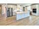 Bright, open kitchen with a center island, stainless steel appliances, and light wood flooring at 738 Crossroad Ct, Powder Springs, GA 30127