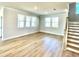 Spacious living room with three bright windows and light-colored hardwood floors at 738 Crossroad Ct, Powder Springs, GA 30127