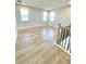 Bright open loft with light-colored hardwood floors and three windows at 738 Crossroad Ct, Powder Springs, GA 30127