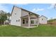 Home's rear exterior boasts a covered patio and lush green lawn at 404 Beacon Way, Villa Rica, GA 30180