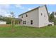 Home's rear exterior boasts a covered patio and lush green lawn at 404 Beacon Way, Villa Rica, GA 30180