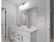 Bathroom featuring a double vanity with sleek white cabinetry and modern faucets at 404 Beacon Way, Villa Rica, GA 30180