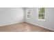 Bright and airy bedroom with neutral walls, wood floors, and two large windows at 404 Beacon Way, Villa Rica, GA 30180