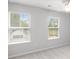Bright bedroom featuring gray walls, plush carpet, and dual windows for natural light at 404 Beacon Way, Villa Rica, GA 30180