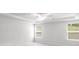 Spacious bedroom with a ceiling fan, tray ceiling, and abundant natural light from two windows at 404 Beacon Way, Villa Rica, GA 30180