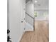 Inviting entryway featuring wood floors, a staircase with white railings, and a visible doorway ahead at 404 Beacon Way, Villa Rica, GA 30180