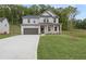 Charming two-story home with a two-car garage, manicured lawn, and inviting front porch at 404 Beacon Way, Villa Rica, GA 30180