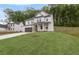 Well-maintained two-story house with a lush green lawn on a sloped lot, surrounded by trees at 404 Beacon Way, Villa Rica, GA 30180
