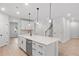 Beautiful kitchen island, white cabinets, modern faucet, and stainless steel dishwasher at 404 Beacon Way, Villa Rica, GA 30180