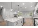 Modern kitchen with a center island, white cabinets, stainless steel appliances, and open floor plan at 404 Beacon Way, Villa Rica, GA 30180