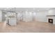 Open-concept living area connecting the kitchen with a cozy fireplace and recessed lighting at 404 Beacon Way, Villa Rica, GA 30180