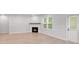Inviting living room featuring a cozy fireplace, ample natural light, and modern flooring at 404 Beacon Way, Villa Rica, GA 30180