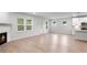 Bright and open living space with light floors, a fireplace, and access to the kitchen at 404 Beacon Way, Villa Rica, GA 30180