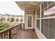 Relaxing covered balcony with a view of the community, showcasing wood flooring and neutral siding at 2382 Gallard St, Lawrenceville, GA 30043