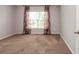 Neutral bedroom featuring a window with floral-patterned curtains and carpet at 2382 Gallard St, Lawrenceville, GA 30043