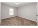 A simple, bright bedroom with carpet and a window at 2382 Gallard St, Lawrenceville, GA 30043