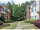 Well-maintained community courtyard featuring lush landscaping and beautiful townhomes in the background at 2382 Gallard St, Lawrenceville, GA 30043