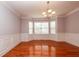 Elegant dining room featuring gleaming hardwood floors, decorative crown molding, and a stylish chandelier at 2382 Gallard St, Lawrenceville, GA 30043