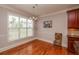 Dining room area with natural light and hardwood flooring adjacent to kitchen with granite counters at 2382 Gallard St, Lawrenceville, GA 30043