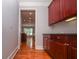 Hallway showcasing custom cabinetry, hardwood floors, and an inviting view into an airy room at 2382 Gallard St, Lawrenceville, GA 30043