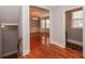 Hallway leading to dining and bath, featuring lovely hardwood flooring at 2382 Gallard St, Lawrenceville, GA 30043