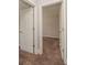 Neutral hallway view with two open doors to bedrooms that feature carpet at 2382 Gallard St, Lawrenceville, GA 30043