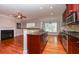 Open kitchen layout with dark wood cabinets, granite countertops, and a fireplace nearby at 2382 Gallard St, Lawrenceville, GA 30043