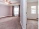 Spacious main bedroom featuring carpet, tray ceilings, a ceiling fan, and an attached closet at 2382 Gallard St, Lawrenceville, GA 30043