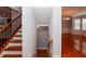 Staircase with wood steps, metal railing, and hardwood flooring at 2382 Gallard St, Lawrenceville, GA 30043