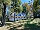 Spacious home with a wrap-around porch and mature trees at 3530 Dahlonega Hwy, Cumming, GA 30028